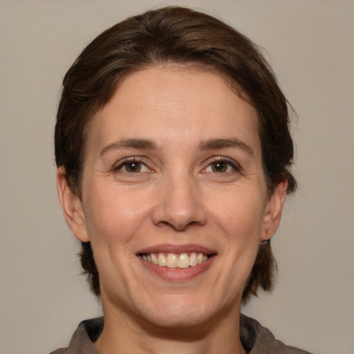 Joyful white adult female with medium  brown hair and brown eyes