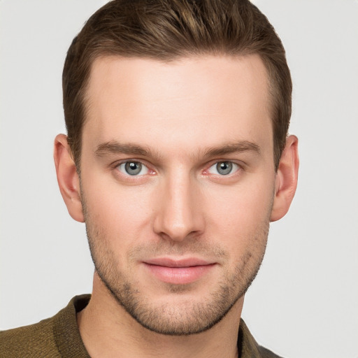 Joyful white young-adult male with short  brown hair and grey eyes