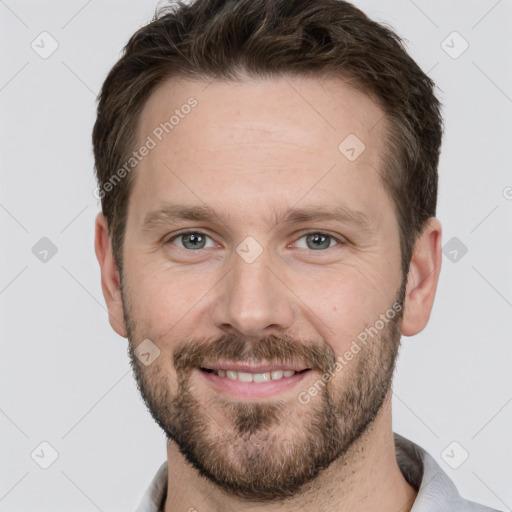 Joyful white adult male with short  brown hair and grey eyes