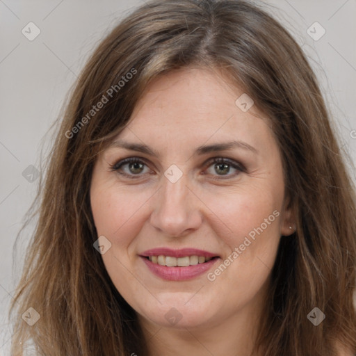 Joyful white adult female with long  brown hair and brown eyes