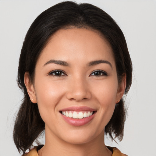 Joyful white young-adult female with medium  brown hair and brown eyes