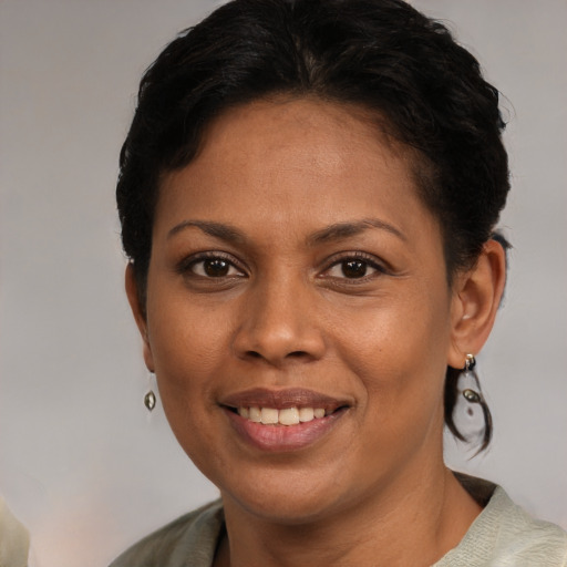Joyful black young-adult female with short  brown hair and brown eyes