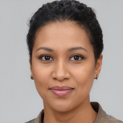 Joyful latino young-adult female with short  black hair and brown eyes