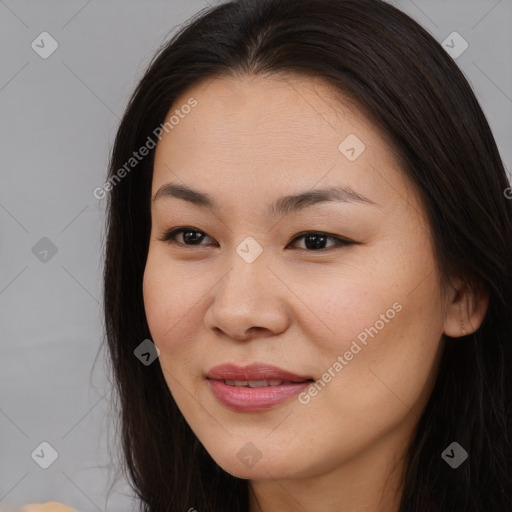 Joyful asian young-adult female with long  brown hair and brown eyes