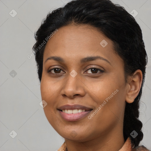 Joyful black young-adult female with long  brown hair and brown eyes