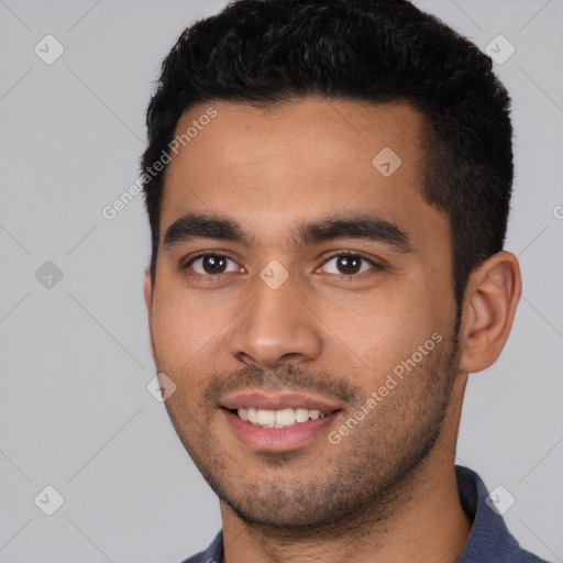 Joyful white young-adult male with short  black hair and brown eyes