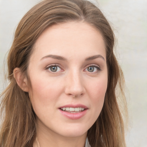 Joyful white young-adult female with long  brown hair and grey eyes