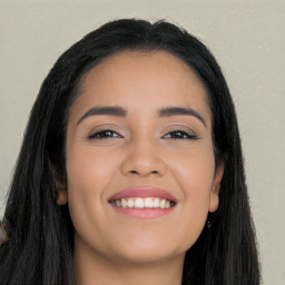 Joyful latino young-adult female with long  black hair and brown eyes