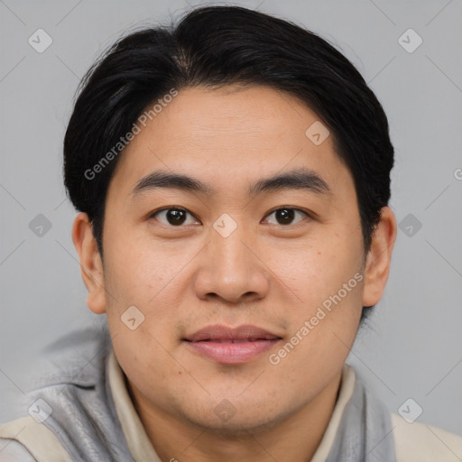 Joyful asian young-adult male with short  brown hair and brown eyes