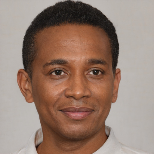 Joyful black adult male with short  brown hair and brown eyes