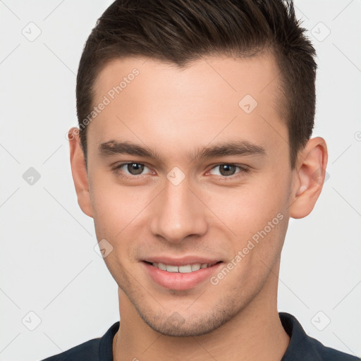 Joyful white young-adult male with short  brown hair and brown eyes