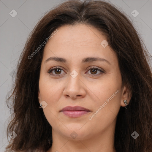 Joyful white adult female with long  brown hair and brown eyes