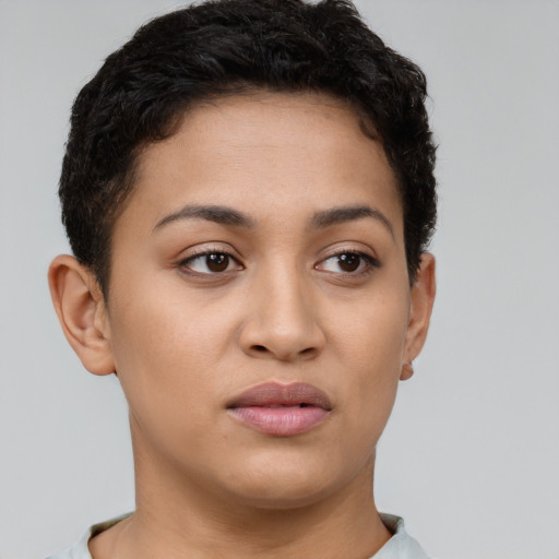 Joyful latino young-adult female with short  brown hair and brown eyes