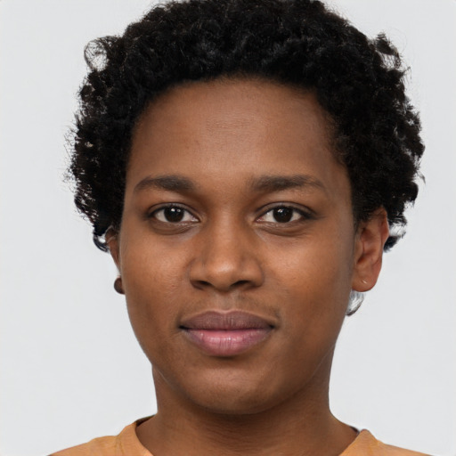 Joyful black young-adult female with short  brown hair and brown eyes