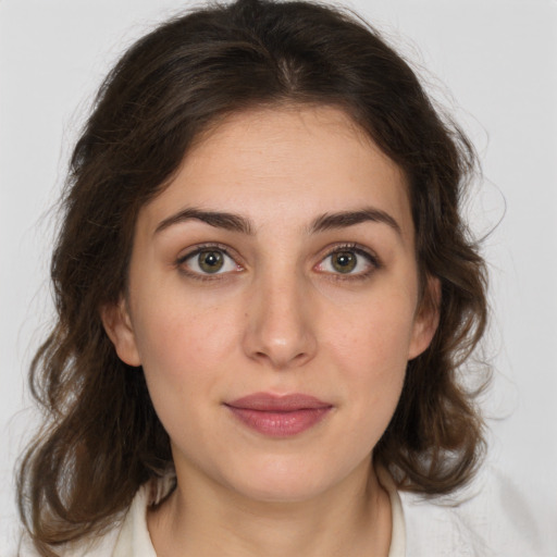 Joyful white young-adult female with medium  brown hair and green eyes