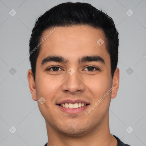 Joyful latino young-adult male with short  black hair and brown eyes