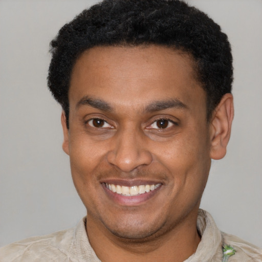 Joyful latino young-adult male with short  brown hair and brown eyes