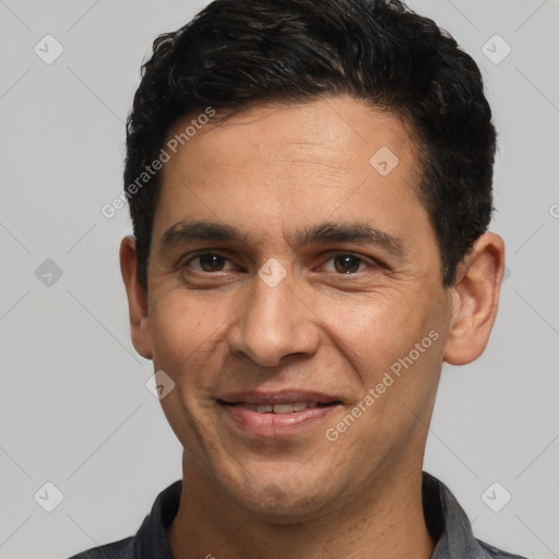 Joyful white adult male with short  black hair and brown eyes