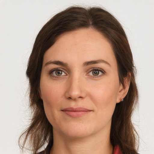 Joyful white young-adult female with long  brown hair and grey eyes