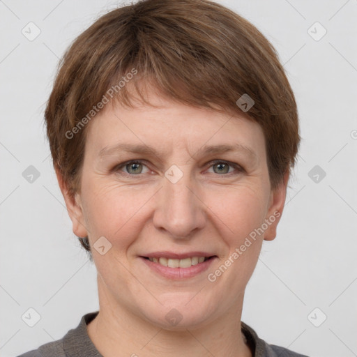 Joyful white adult female with short  brown hair and grey eyes