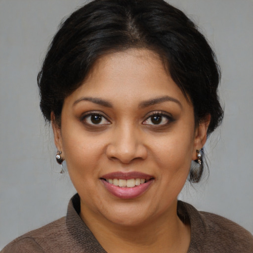 Joyful black young-adult female with medium  brown hair and brown eyes