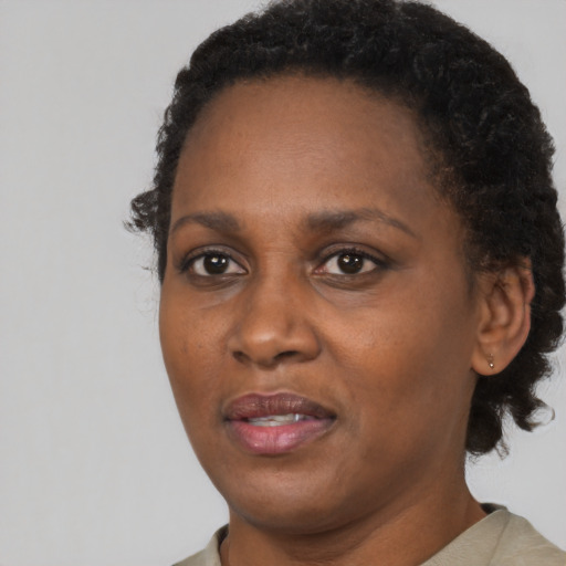 Joyful black adult female with short  brown hair and brown eyes