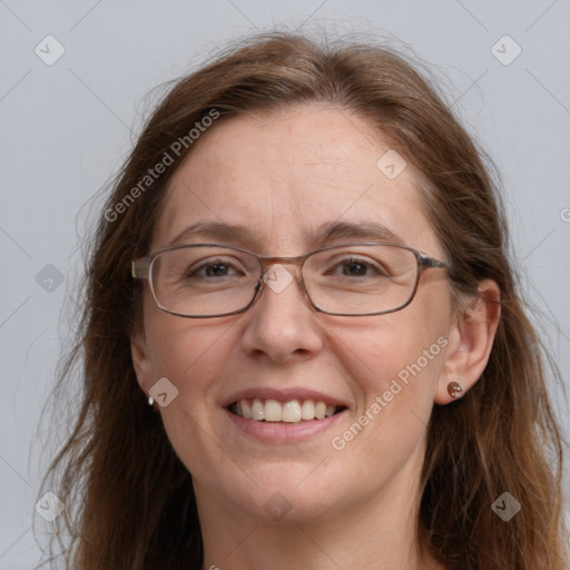 Joyful white adult female with long  brown hair and grey eyes