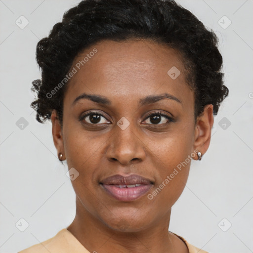 Joyful black young-adult female with short  black hair and brown eyes
