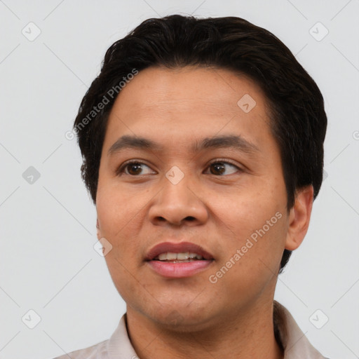 Joyful asian young-adult male with short  black hair and brown eyes