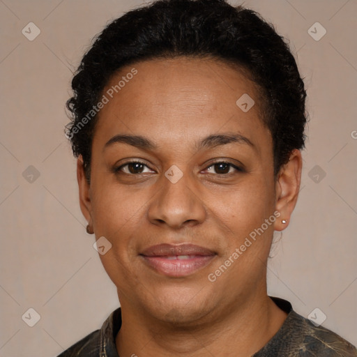 Joyful black young-adult female with short  black hair and brown eyes