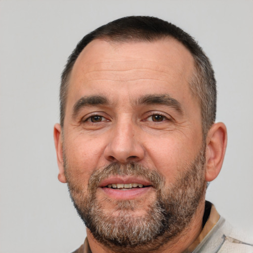 Joyful white adult male with short  black hair and brown eyes