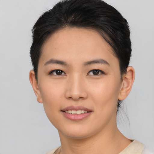 Joyful asian young-adult female with short  black hair and brown eyes