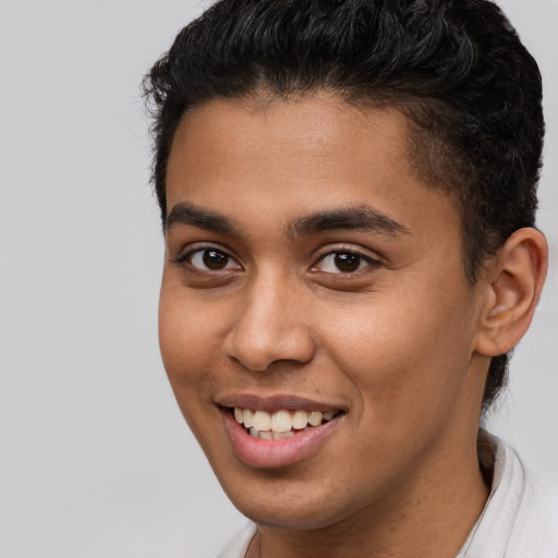 Joyful latino young-adult male with short  brown hair and brown eyes