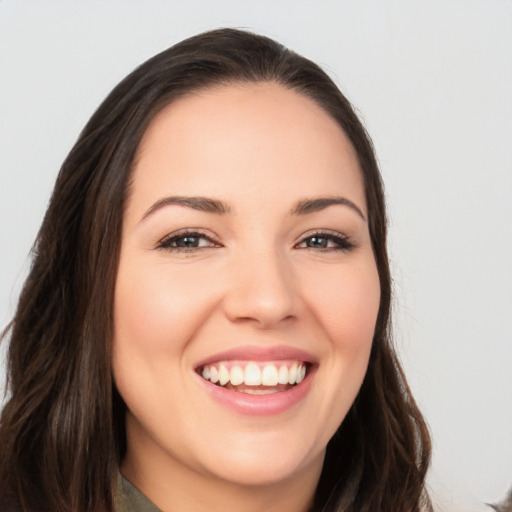 Joyful white young-adult female with long  brown hair and brown eyes