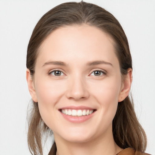 Joyful white young-adult female with long  brown hair and grey eyes