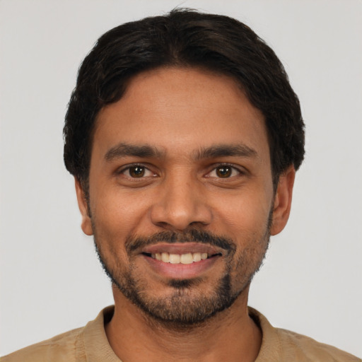 Joyful latino young-adult male with short  black hair and brown eyes