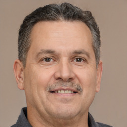 Joyful white middle-aged male with short  brown hair and brown eyes