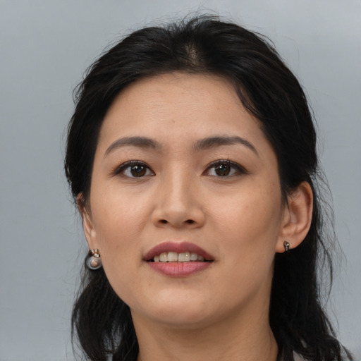 Joyful asian adult female with medium  brown hair and brown eyes