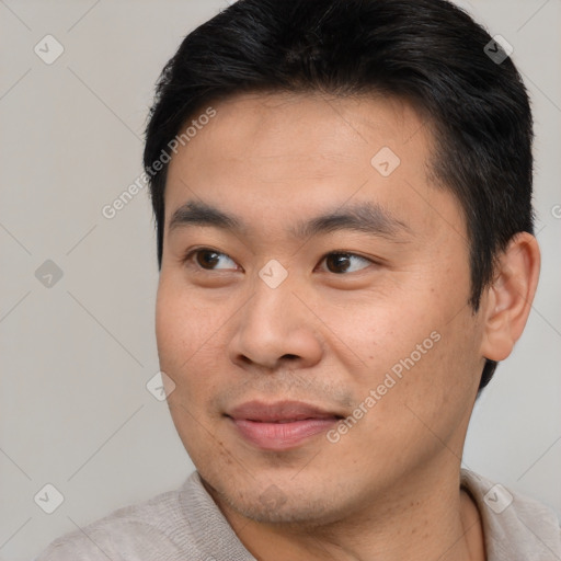 Joyful asian young-adult male with short  brown hair and brown eyes