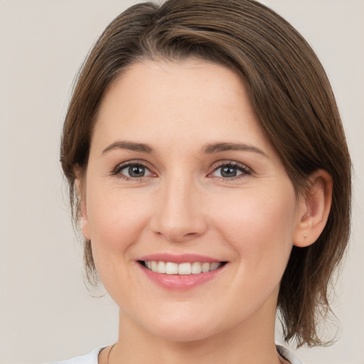 Joyful white young-adult female with medium  brown hair and brown eyes