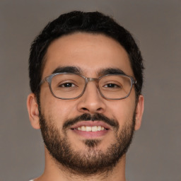 Joyful latino young-adult male with short  brown hair and brown eyes