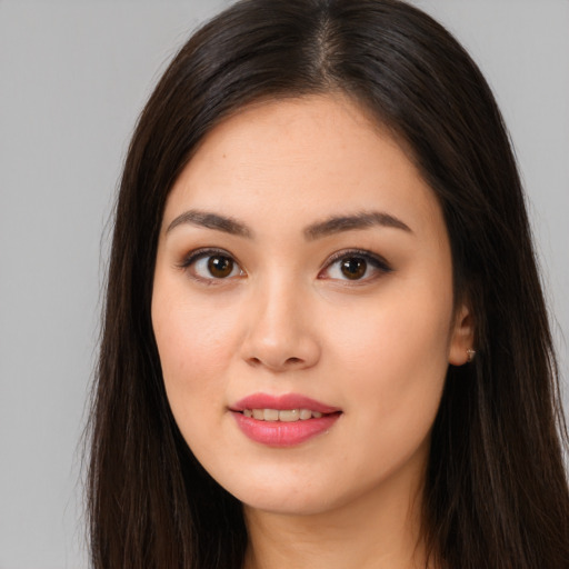 Joyful asian young-adult female with long  brown hair and brown eyes