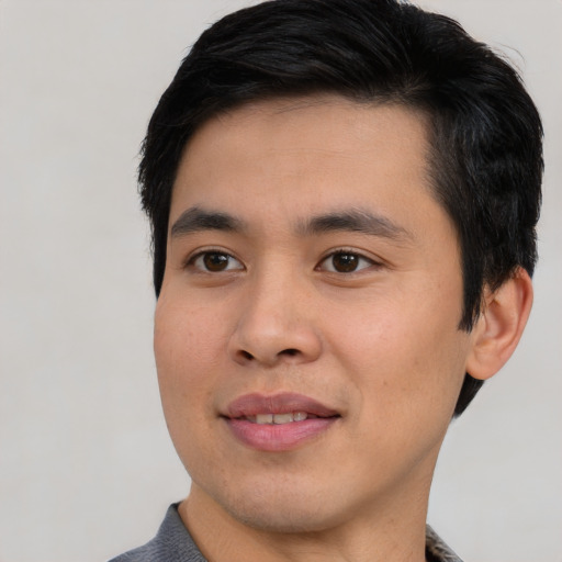 Joyful asian young-adult male with short  black hair and brown eyes