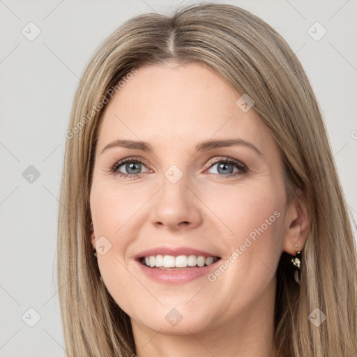 Joyful white young-adult female with long  brown hair and grey eyes