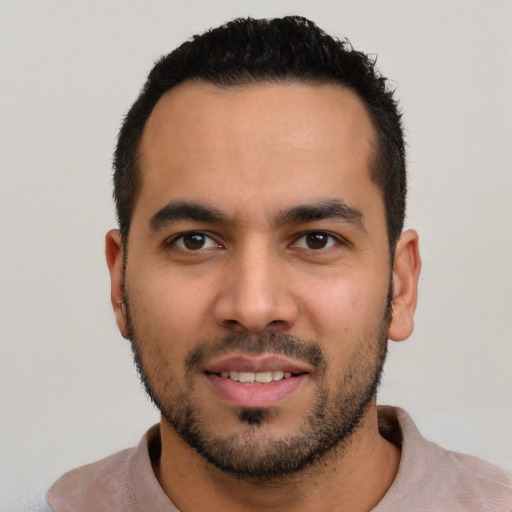 Joyful white young-adult male with short  black hair and brown eyes