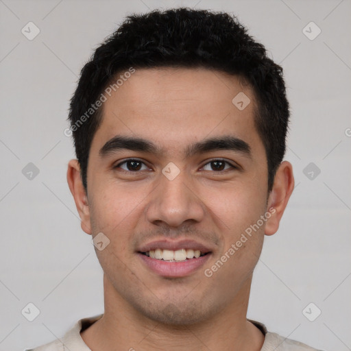 Joyful latino young-adult male with short  brown hair and brown eyes