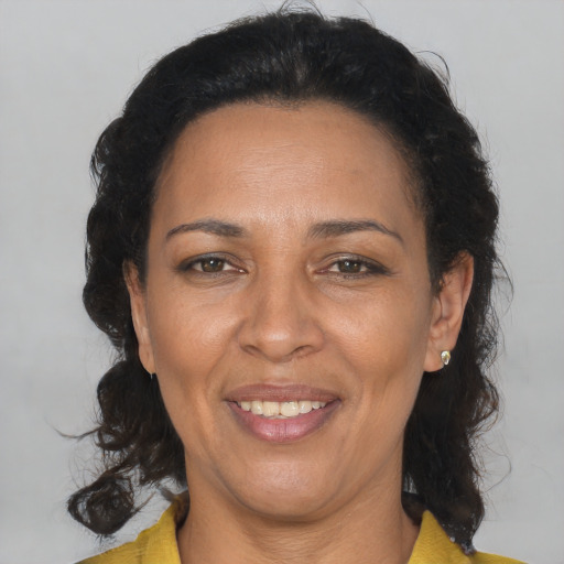 Joyful latino adult female with medium  brown hair and brown eyes