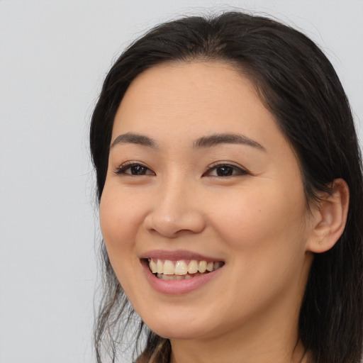 Joyful white young-adult female with medium  black hair and brown eyes