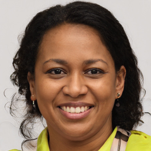 Joyful latino adult female with medium  brown hair and brown eyes