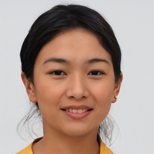 Joyful asian young-adult female with short  brown hair and brown eyes